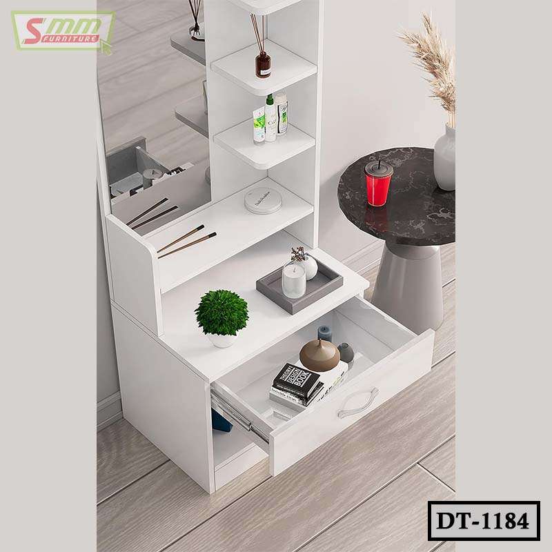 White modern dressing table with shelves, drawer, and mirror, organized with cosmetics and decor.