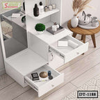 Modern white dressing table with open drawers, mirror, plants, and decorative accessories.