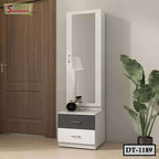 Modern white dressing table with mirror, drawers, and decorative plant in a bedroom corner
