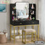 Modern black and gold dressing table with mirror, shelves, stool, and makeup accessories