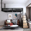 Modern duplex loft bed with staircase above a living area with a brown sofa and coffee tables