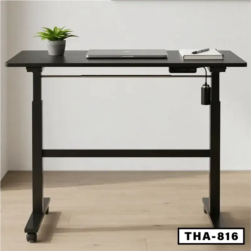 Electric folding desk with black frame, laptop, notebook, and potted plant in home office Main image