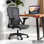 Ergonomic office chair with mesh backrest and adjustable armrests beside a modern desk