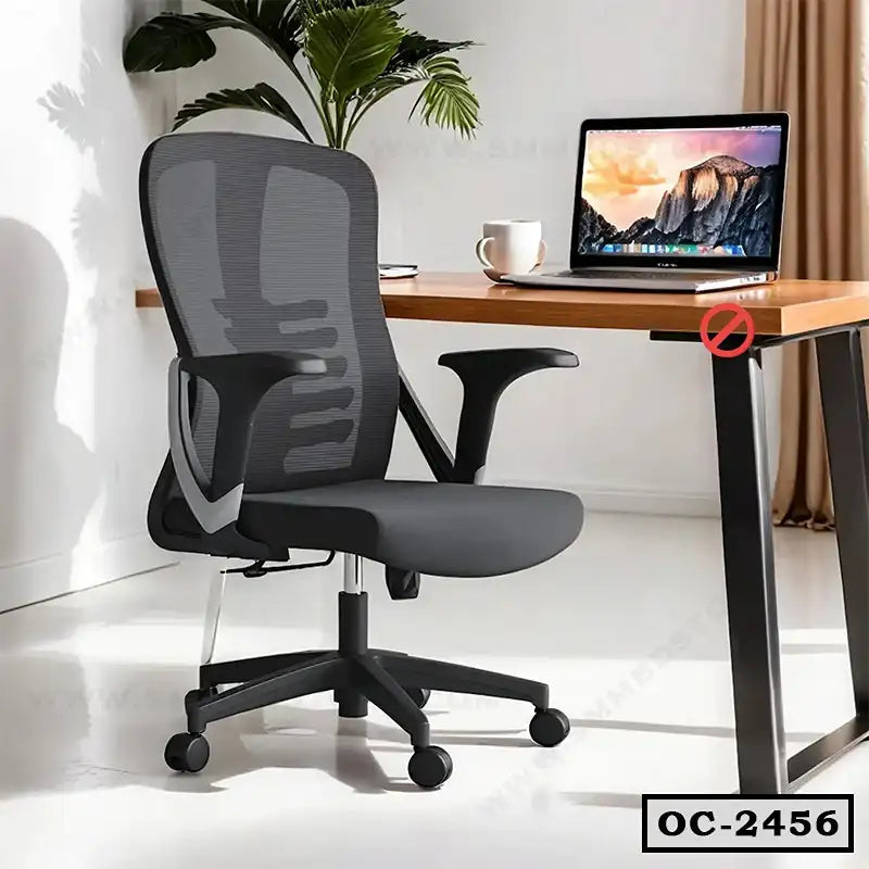 Ergonomic office chair with mesh backrest and adjustable armrests beside a modern desk