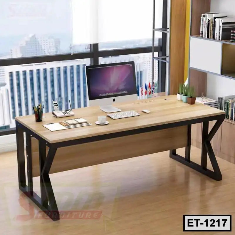Modern executive office table with metal frame, desktop computer, and organized accessories in a workspace.