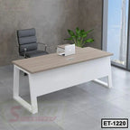 Modern executive office table with wood top, white legs, black chair, and indoor plant