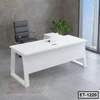 Modern white executive office table with black chair and indoor plant in a contemporary office