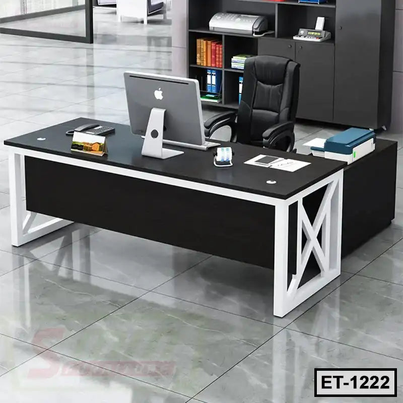 Modern executive office table with black surface, white metal frame, office chair and computer
