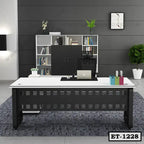 Modern executive office table with laptop, files, and organizer in a contemporary office setting