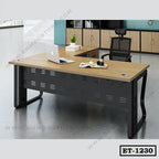 Modern executive office table with black frame, wooden top, mesh chair, and workspace setup