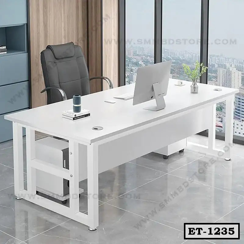 Modern white executive office desk with black chair and computer in a high-rise workspace