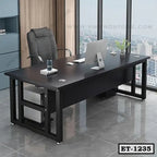 Modern black executive office table with computer, chair, and city view window.