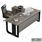 Modern executive office desk with black frame, ergonomic chair, and storage cabinet
