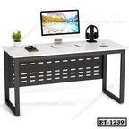 Modern executive office table with computer, headphones, plant, and accessories.
