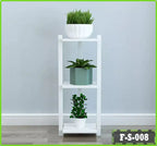 Modern white flower rack for living room with three potted plants against a light wall