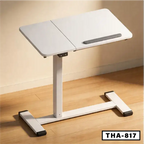 Adjustable folding laptop desk with white tabletop, T-shaped base, and anti-slip bar, placed on wooden floor