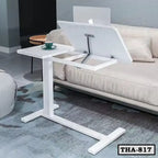Height adjustable white laptop table with tilting surface in a modern living room
