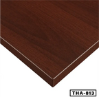 Close-up of a woodgrain finish desk tabletop, rectangular edge, dark brown color
