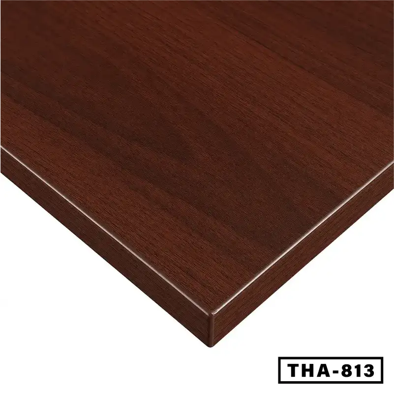 Close-up of a woodgrain finish desk tabletop, rectangular edge, dark brown color
