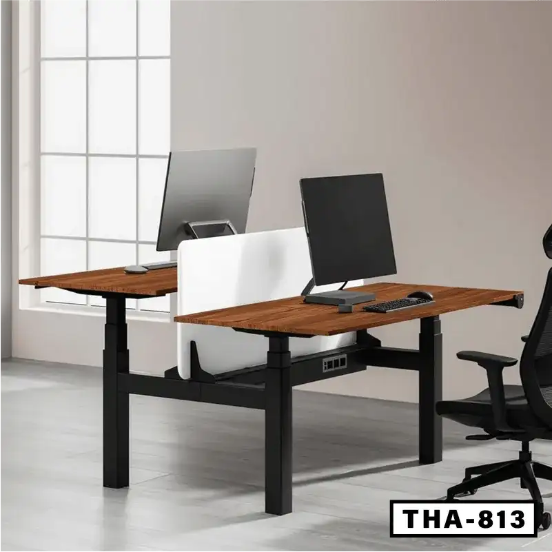 Height adjustable workstation desk with dual wooden desktops, monitors, and ergonomic office chair.