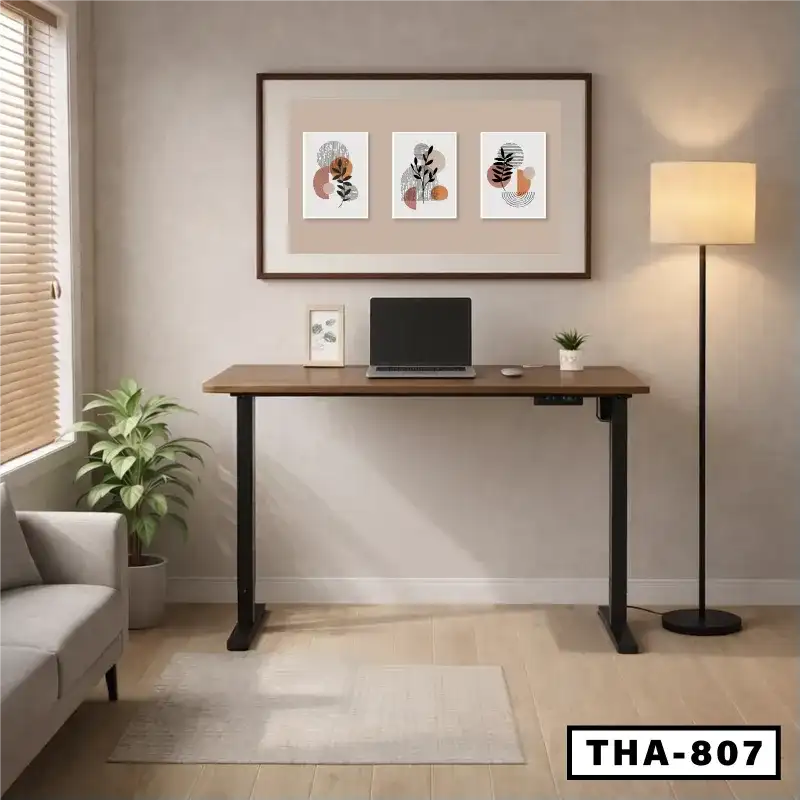 Modern home office with electric adjustable desk, laptop, indoor plant, and wall art Main image
