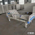 Adjustable hospital bed with metal rails and wheels in a storage warehouse