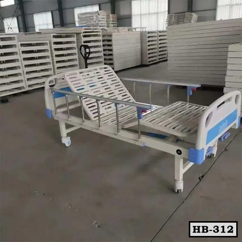 Adjustable hospital bed with metal rails and wheels in a storage warehouse
