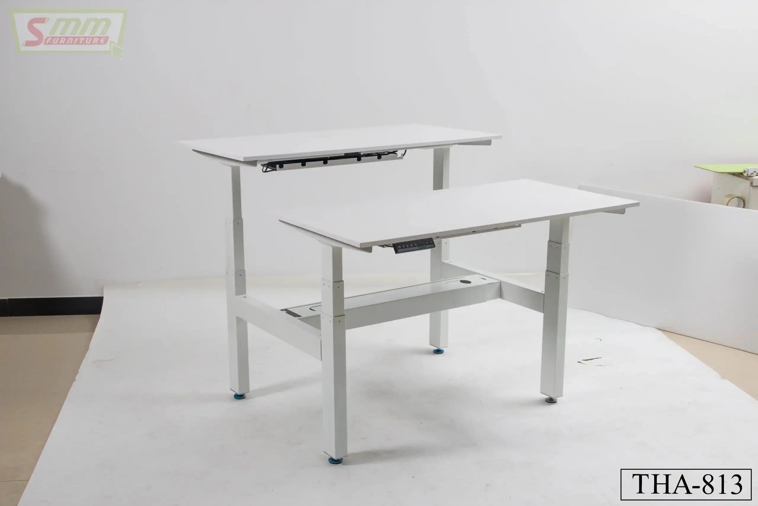 White adjustable height office desk with dual work surfaces, model THA-813, in studio setting