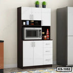 Modern kitchen shelf with white cabinets, microwave, potted plants, and storage drawers