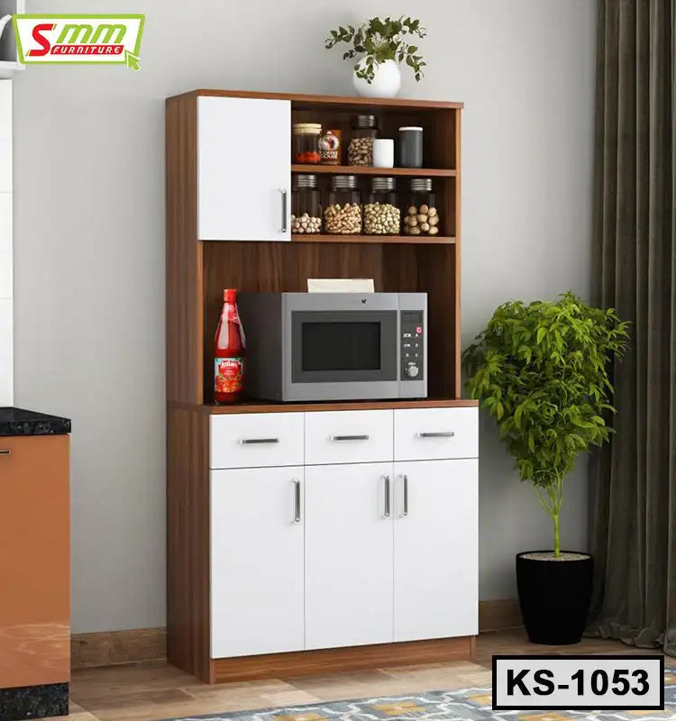 Wooden kitchen shelf with white cabinets, microwave, storage jars, and potted plant