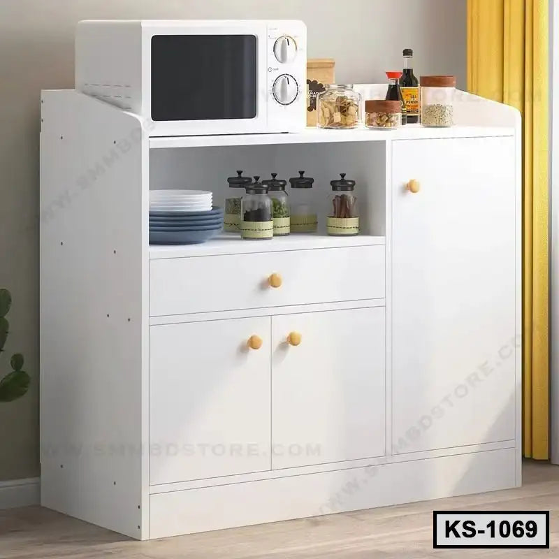 White kitchen storage cabinet with microwave, plates, spice jars, and pantry items