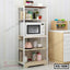 Modern kitchen shelf organizer with microwave, jars, and utensils on multiple tiers