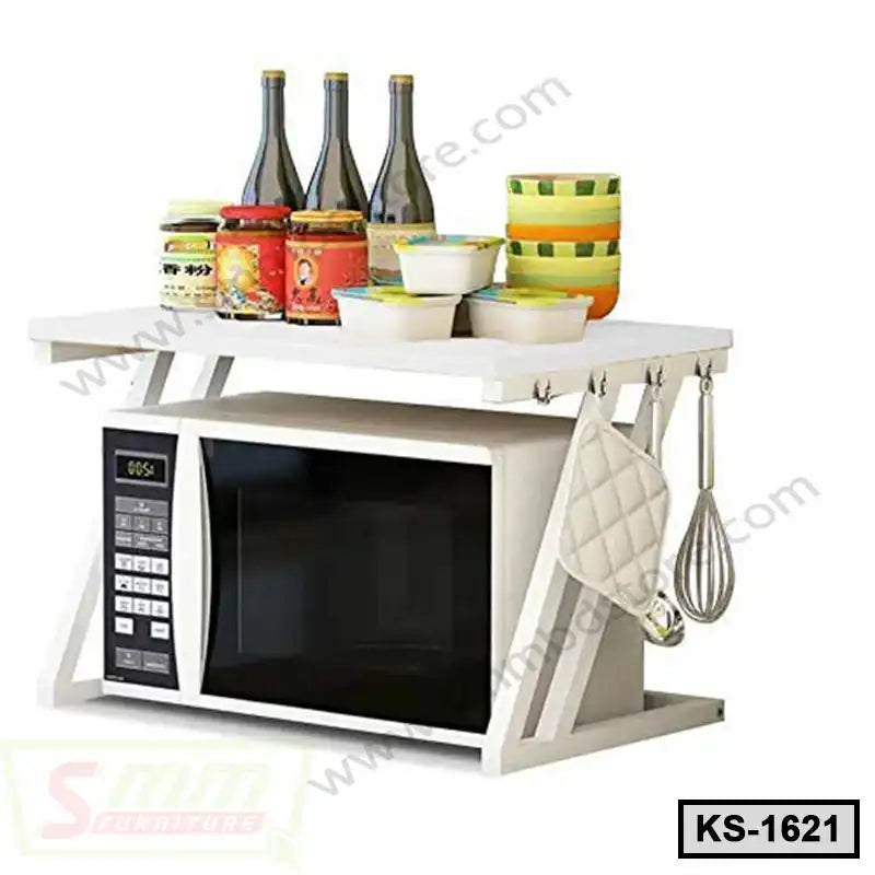 Modern white kitchen shelf with microwave, dishes, glass bottles, jars, and hanging utensils