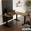 L-shaped height adjustable desk with wood finish and black legs in a modern home office