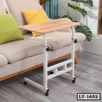 Adjustable laptop table with wheels beside a modern sofa in a home living room