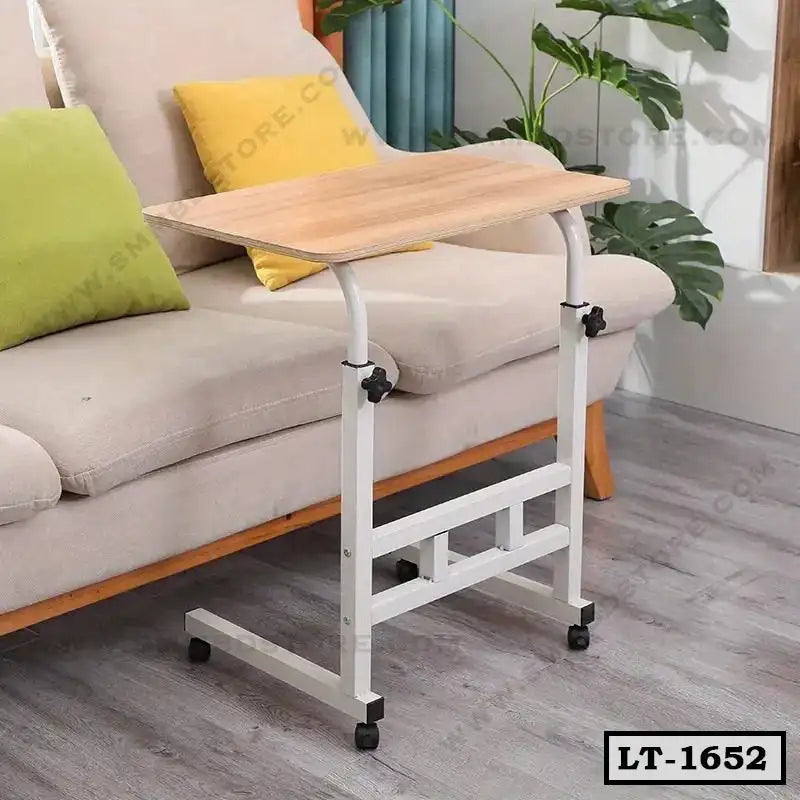 Adjustable laptop table with wheels beside a modern sofa in a home living room