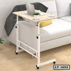 Adjustable rolling laptop table beside sofa in modern living room with laptop and coffee cup