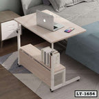 Modern adjustable laptop table with side book storage, placed next to a bed in a bedroom.