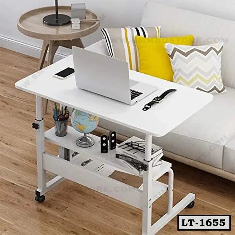 Modern white rolling laptop table with shelves, beside a sofa in a living room setting