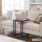 Rolling laptop table with wooden top beside beige sofa in modern living room