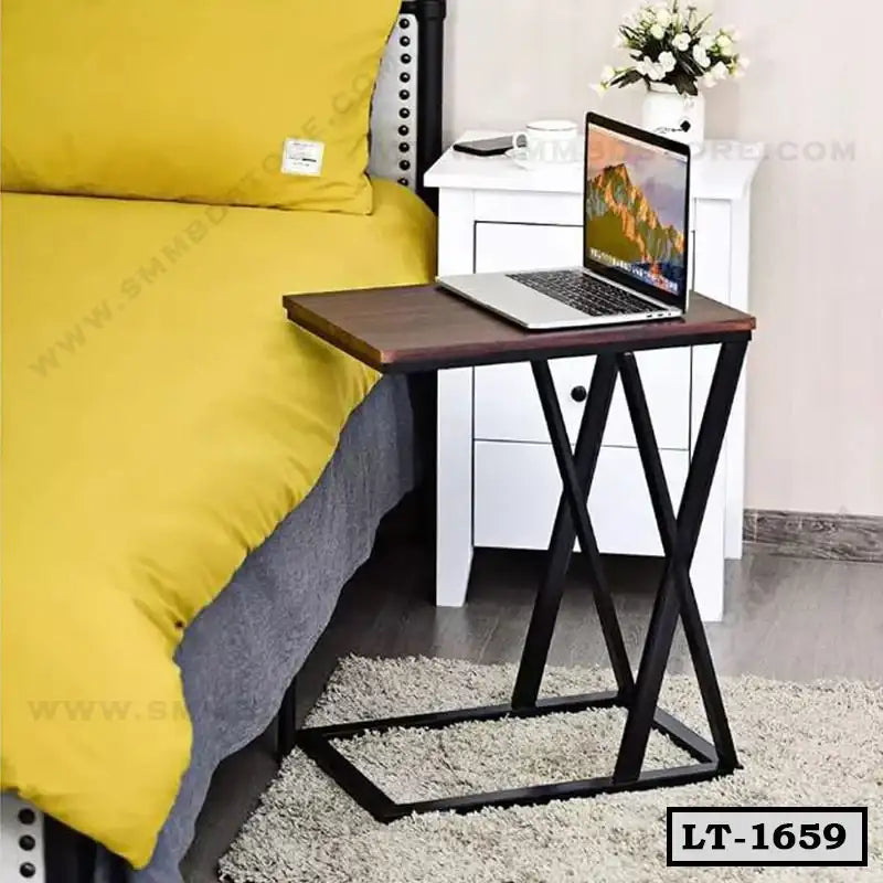 Modern laptop table with black metal frame beside bed, perfect for home or office use Main image