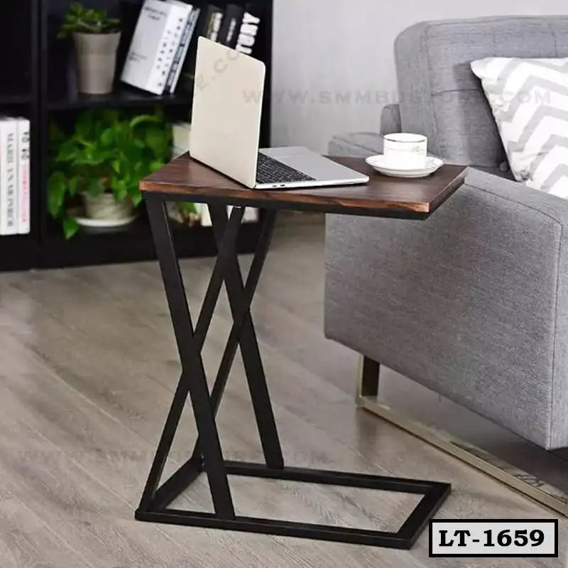 Modern laptop table with metal frame beside gray sofa in home office setting
