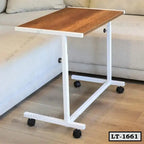 Modern wooden laptop table with white metal frame and wheels next to a sofa