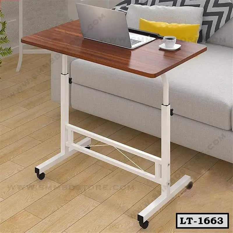 Adjustable laptop table with wheels in living room, wood top, white metal frame, beside sofa.
