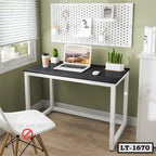 Modern minimalist laptop table with metal frame, black top, chair, and indoor plants in home office setting