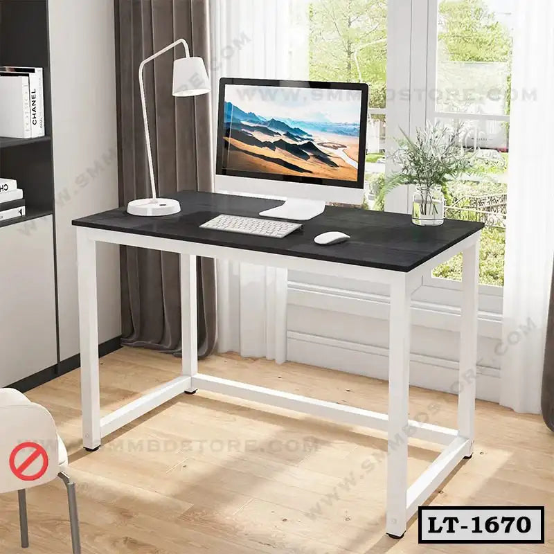 Modern home office desk with black tabletop, white frame, and computer in bright room
