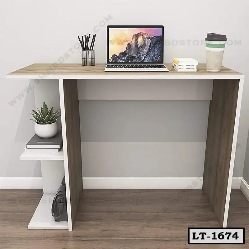 Modern office desk with laptop, coffee cup, books, and plant on wooden floor Main image