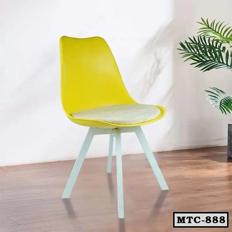 Modern yellow metal tulip chair with cushion and white legs in a home interior