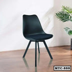 Modern black metal tulip chair with cushioned seat on wooden floor, indoor setting