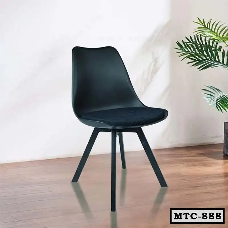 Modern black metal tulip chair with cushioned seat on wooden floor, indoor setting